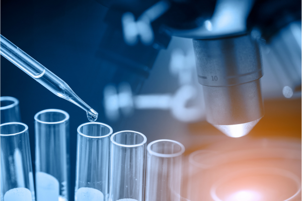 Modern pharmaceutical laboratory with scientists in white coats working under sterile conditions